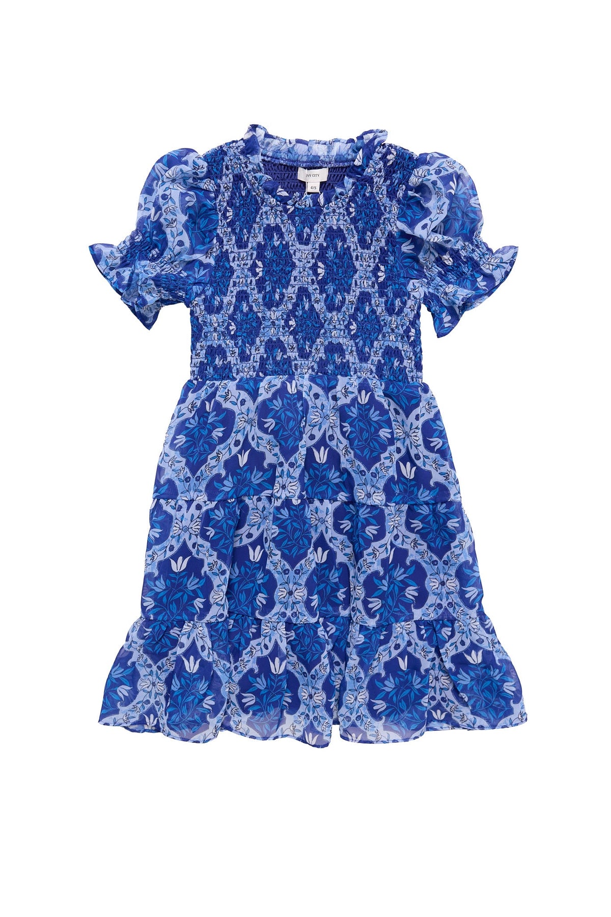 Mini Cordelia Dress in Trellis Foulard by Ivy City Co, a blue and white short-sleeve girls’ chiffon dress featuring a floral pattern, puffed sleeves, ruffled hem, and smocked bodice, displayed flat against a white background. Perfect for coordinated family outfits.