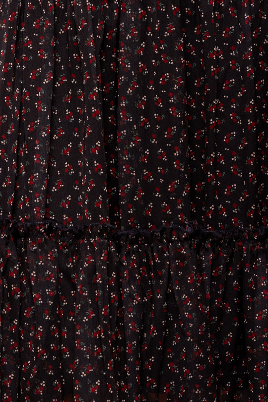 Close-up of the Ivy City Co Madeline Dress in Black Ditsy Floral, showcasing its ruffled seam and delicate white and red ditsy floral print—designed to be both nursing friendly and maternity friendly for comfortable, stylish wear.