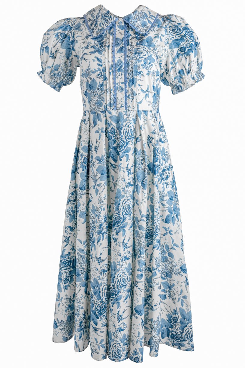 The Sophia Dress in Blue Floral by Ivy City Co is a vintage-inspired, ankle-length dress with puffed short sleeves, a wide collar, and a nursing-friendly design on a white background.
