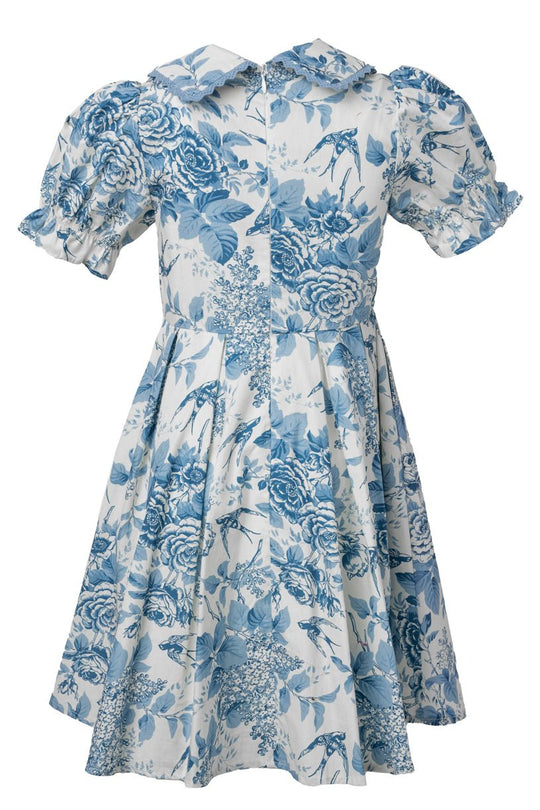 The Mini Sophia Dress in Blue Floral by Ivy City Co features puff short sleeves, a fitted waist, ruffled cuffs, and a wide pointed collar—making it the perfect spring dress for girls.